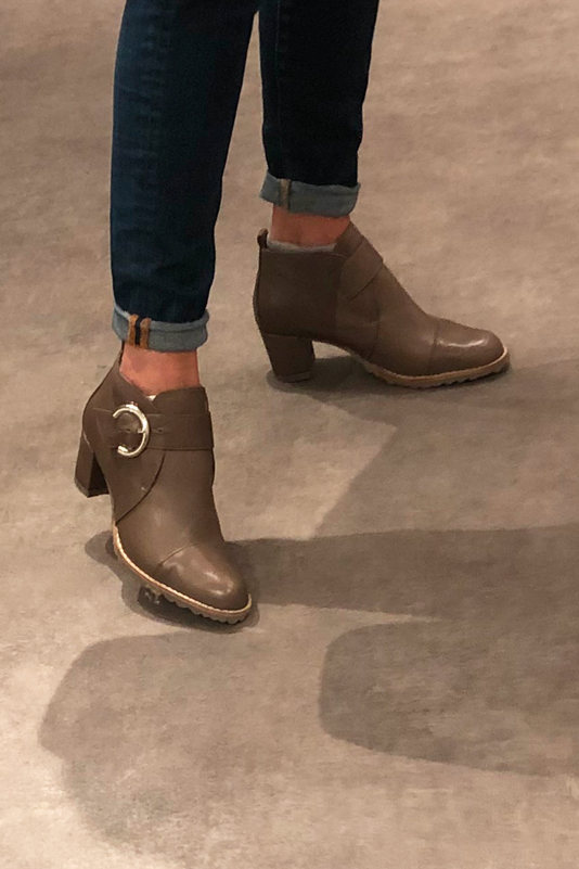 Chocolate brown women's ankle boots with buckles at the front. Round toe. Medium block heels. Worn view - Florence KOOIJMAN